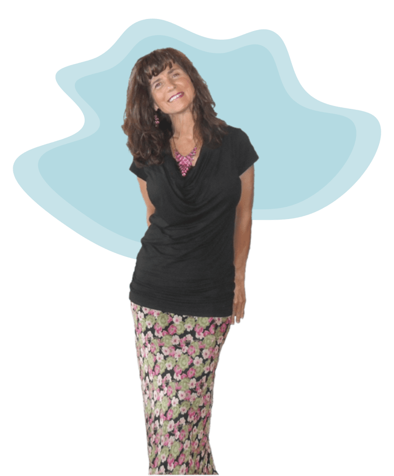 Young woman with long hair wearing a black top and floral skirt.
